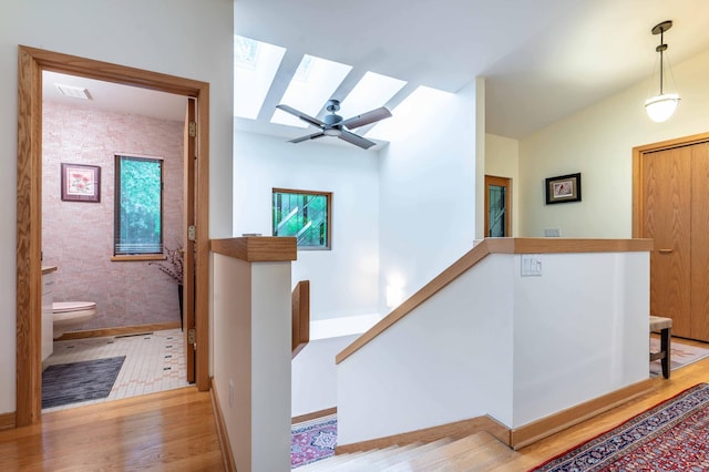 28647 State Highway 78, Otter Tail Twp, MN 56515 - hallway featuring an upstairs landing, a skylight, and wood finished floors