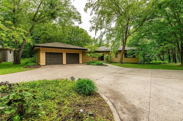 28647 State Highway 78, Otter Tail Twp, MN 56515 - view of front of home featuring stucco siding, driveway, an attached garage, and a front yard