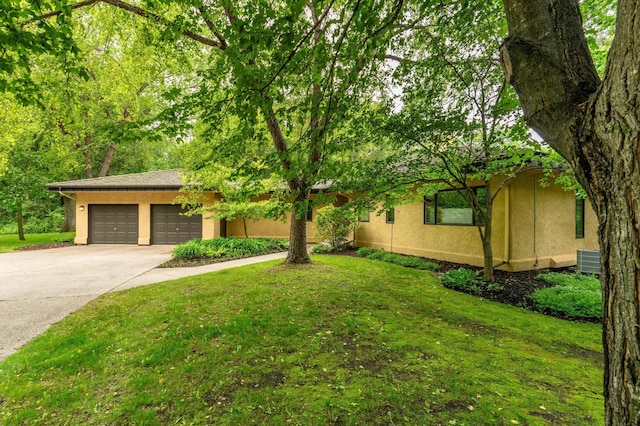 28647 State Highway 78, Otter Tail Twp, MN 56515 - view of front of home with stucco siding, concrete driveway, a garage, and a front lawn