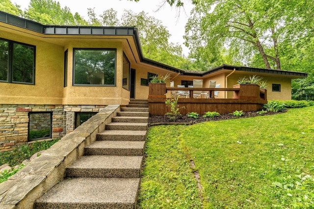 28647 State Highway 78, Otter Tail Twp, MN 56515 - view of front of property with stucco siding, stairway, a front lawn, and stone siding