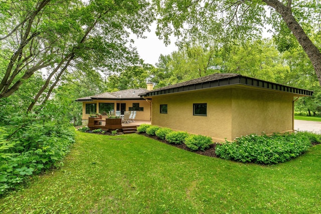 28647 State Highway 78, Otter Tail Twp, MN 56515 - rear view of property with a wooden deck, stucco siding, and a lawn