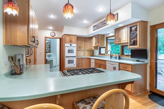 28647 State Highway 78, Otter Tail Twp, MN 56515 - kitchen with double oven, cooktop, a kitchen breakfast bar, light countertops, and recessed lighting