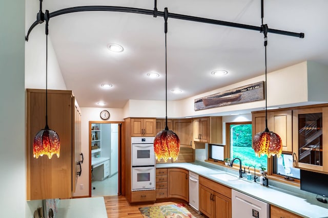 28647 State Highway 78, Otter Tail Twp, MN 56515 - kitchen with white appliances, light countertops, hanging light fixtures, and light wood-style floors