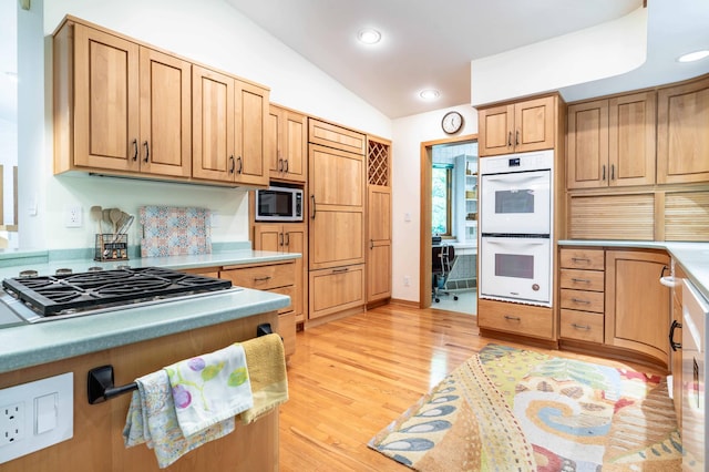 28647 State Highway 78, Otter Tail Twp, MN 56515 - kitchen with built in appliances, lofted ceiling, light wood finished floors, recessed lighting, and light countertops