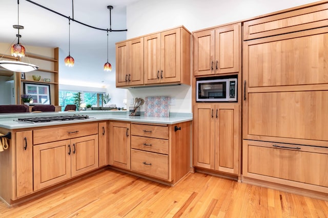 28647 State Highway 78, Otter Tail Twp, MN 56515 - kitchen featuring stainless steel appliances, light countertops, decorative light fixtures, light brown cabinets, and light wood-type flooring