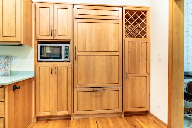 28647 State Highway 78, Otter Tail Twp, MN 56515 - kitchen with stainless steel microwave, light wood-type flooring, and light countertops