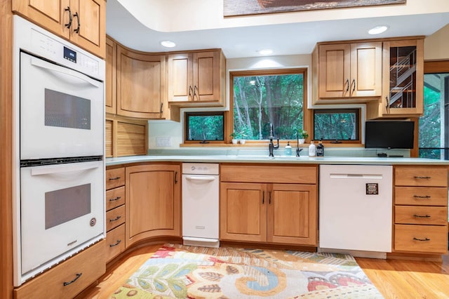28647 State Highway 78, Otter Tail Twp, MN 56515 - kitchen with white appliances, light countertops, light wood-type flooring, recessed lighting, and glass insert cabinets