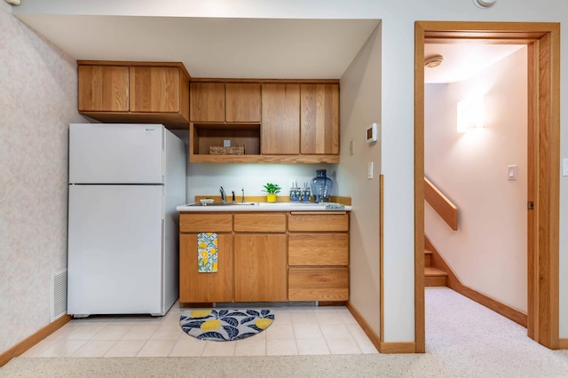 28647 State Highway 78, Otter Tail Twp, MN 56515 - kitchen featuring freestanding refrigerator, brown cabinetry, light countertops, and open shelves