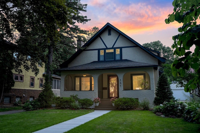 141 Rustic Ldg W, Minneapolis, MN 55419 - tudor home with a front yard, a porch, and stucco siding