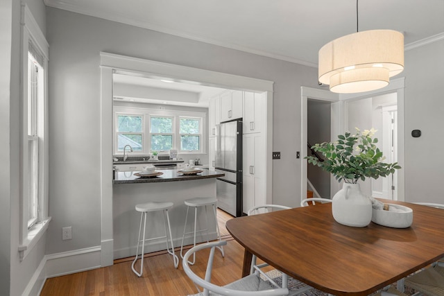 141 Rustic Ldg W, Minneapolis, MN 55419 - dining area featuring light wood-style floors and crown molding