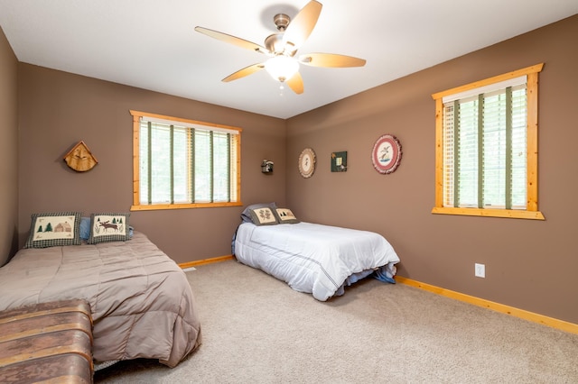 12088 Sylvan Dr SW, Pillager, MN 56473 - bedroom with multiple windows, baseboards, carpet, and ceiling fan