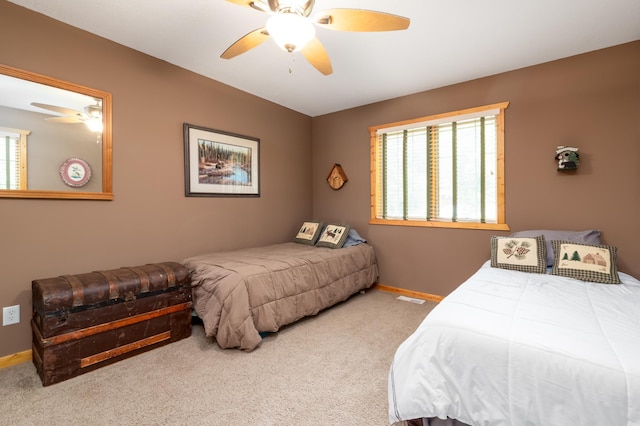 12088 Sylvan Dr SW, Pillager, MN 56473 - carpeted bedroom with multiple windows, baseboards, and ceiling fan