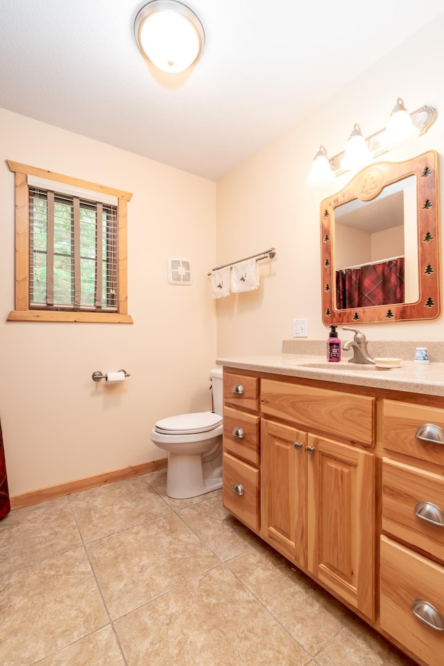 12088 Sylvan Dr SW, Pillager, MN 56473 - bathroom with vanity, toilet, tile patterned flooring, and baseboards