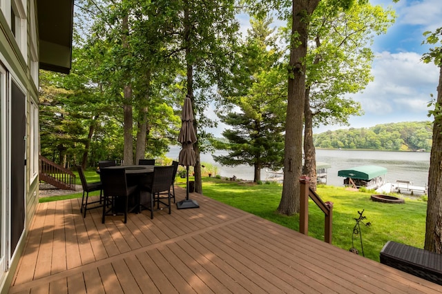 12088 Sylvan Dr SW, Pillager, MN 56473 - wooden terrace featuring a water view, a lawn, outdoor dining area, and area for grilling
