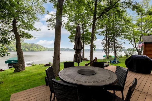 12088 Sylvan Dr SW, Pillager, MN 56473 - wooden deck with area for grilling, a yard, a water view, and outdoor dining space