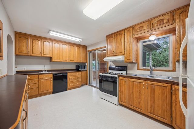 16584 River Rd, Green Prairie Twp, MN 56345 - kitchen featuring white appliances, under cabinet range hood, brown cabinetry, and light flooring