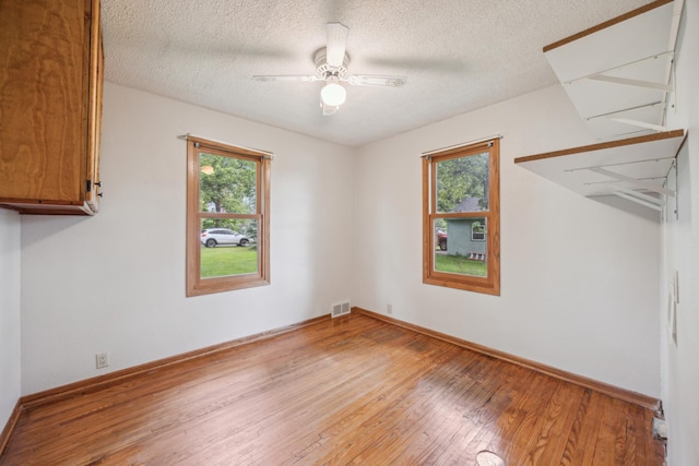 16584 River Rd, Green Prairie Twp, MN 56345 - spare room with light wood-type flooring, ceiling fan, and a textured ceiling