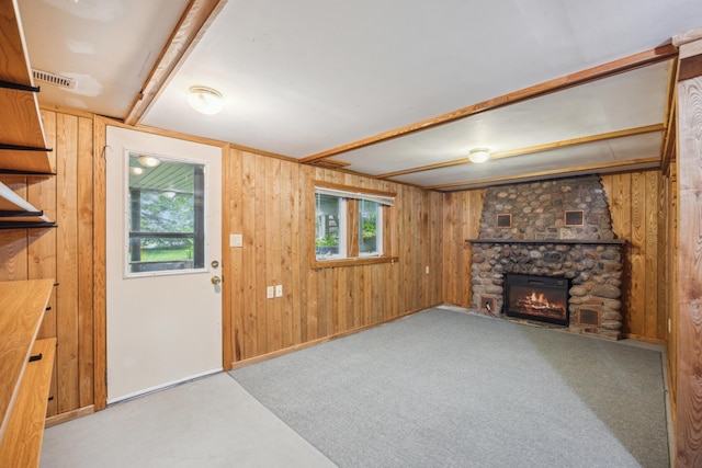 16584 River Rd, Green Prairie Twp, MN 56345 - unfurnished living room with wood walls, a fireplace, and carpet