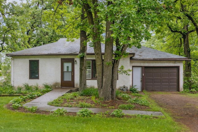 16584 River Rd, Green Prairie Twp, MN 56345 - view of front of house with stucco siding, dirt driveway, and a garage