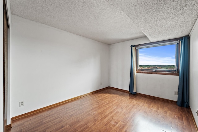 66 9th St E Unit 1806, Saint Paul, MN 55101 - unfurnished room featuring wood finished floors and a textured ceiling