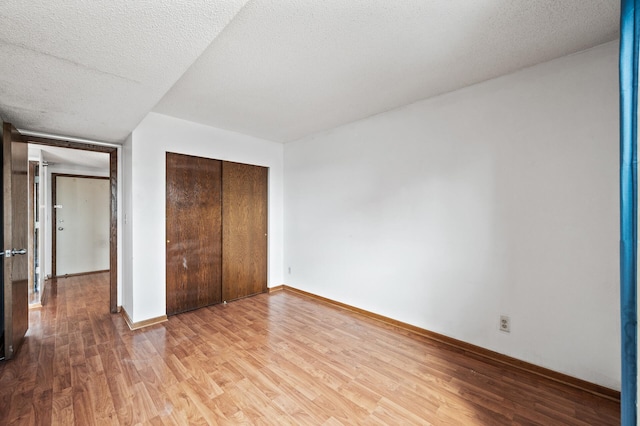 66 9th St E Unit 1806, Saint Paul, MN 55101 - unfurnished bedroom with light wood finished floors, a closet, and a textured ceiling