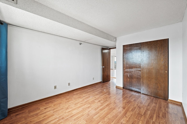 66 9th St E Unit 1806, Saint Paul, MN 55101 - unfurnished bedroom featuring light wood-style flooring and a textured ceiling