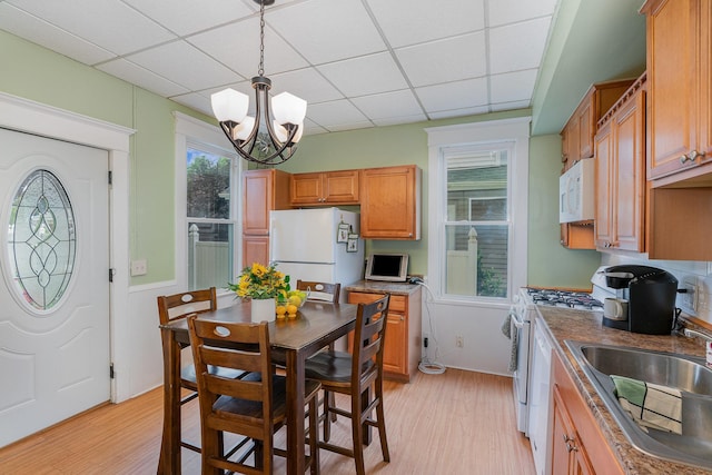 190 Annapolis St E, West Saint Paul, MN 55118 - kitchen featuring white appliances, a paneled ceiling, light wood-type flooring, a chandelier, and decorative light fixtures
