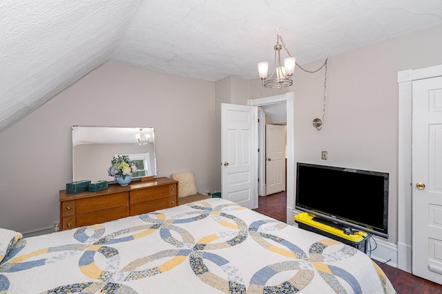 190 Annapolis St E, West Saint Paul, MN 55118 - bedroom with a chandelier, dark wood finished floors, lofted ceiling, and a textured ceiling