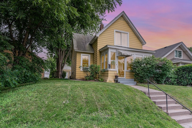 190 Annapolis St E, West Saint Paul, MN 55118 - bungalow with a shingled roof, a front yard, and a chimney