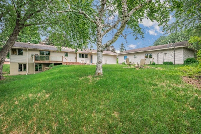 2434 Southcrest Ave E, Maplewood, MN 55119 - rear view of house with a deck, a yard, and a chimney