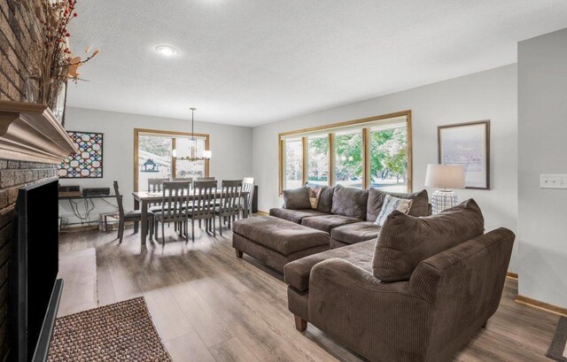 2434 Southcrest Ave E, Maplewood, MN 55119 - living room with plenty of natural light, light wood-type flooring, and a chandelier