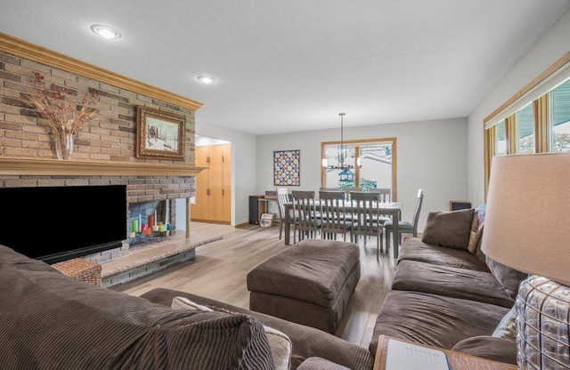 2434 Southcrest Ave E, Maplewood, MN 55119 - living area with a chandelier, light wood-style floors, recessed lighting, a fireplace, and baseboards