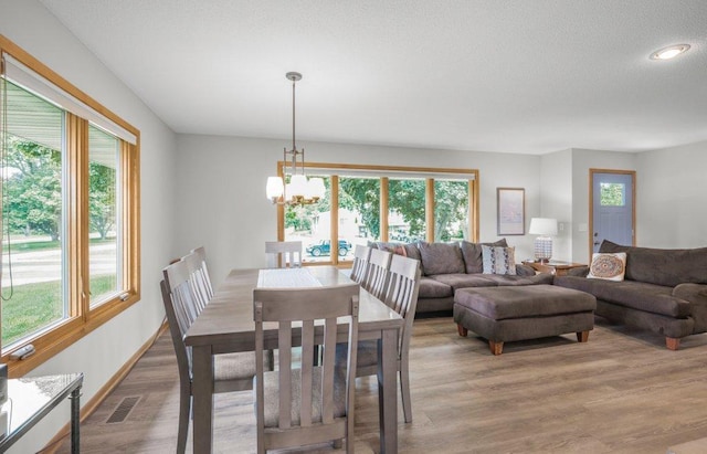 2434 Southcrest Ave E, Maplewood, MN 55119 - dining room featuring plenty of natural light, a chandelier, light wood-style flooring, a textured ceiling, and recessed lighting
