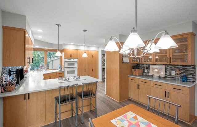 2434 Southcrest Ave E, Maplewood, MN 55119 - kitchen with white appliances, a sink, backsplash, a peninsula, and glass insert cabinets
