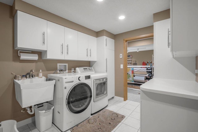 2434 Southcrest Ave E, Maplewood, MN 55119 - washroom with cabinet space, washing machine and clothes dryer, baseboards, recessed lighting, and light tile patterned floors