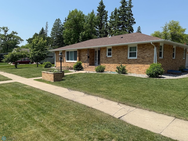 409 1st Ave E, Ada, MN 56510 - single story home with a front yard and brick siding