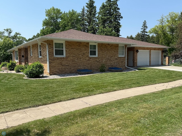 409 1st Ave E, Ada, MN 56510 - ranch-style house with brick siding, an attached garage, a front lawn, and driveway