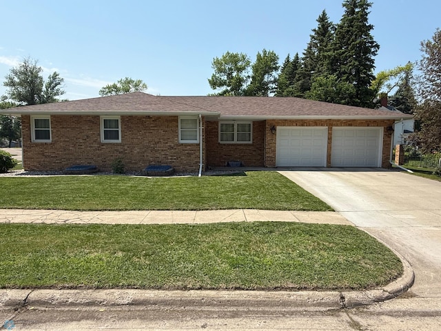 409 1st Ave E, Ada, MN 56510 - ranch-style home with an attached garage, concrete driveway, brick siding, and a front yard