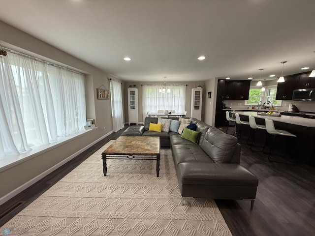 409 1st Ave E, Ada, MN 56510 - living area with dark wood-style floors, recessed lighting, and a chandelier
