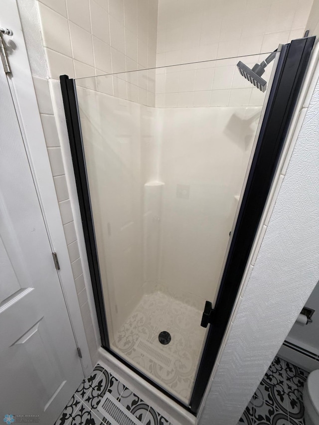 409 1st Ave E, Ada, MN 56510 - bathroom with a stall shower, a baseboard heating unit, and tile patterned floors