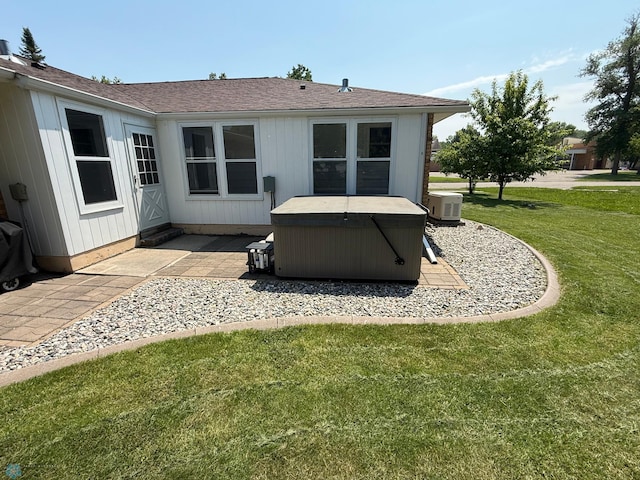 409 1st Ave E, Ada, MN 56510 - back of house with a hot tub, a patio, a yard, and a shingled roof
