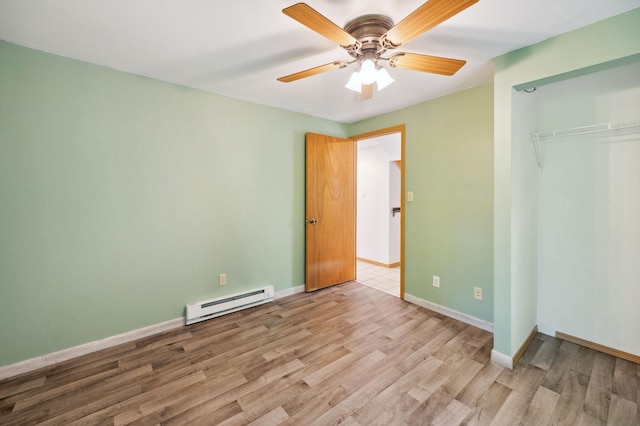 5578 Cloquet Rd, Midway Twp, MN 55810 - unfurnished bedroom with a baseboard heating unit, light wood-style flooring, a closet, and ceiling fan