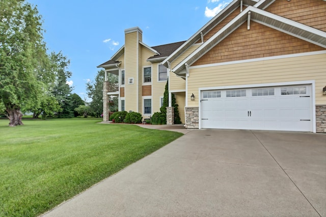 755 Hickory Way Unit 2, Lake City, MN 55041 - view of front of property featuring a front lawn, concrete driveway, stone siding, and a chimney