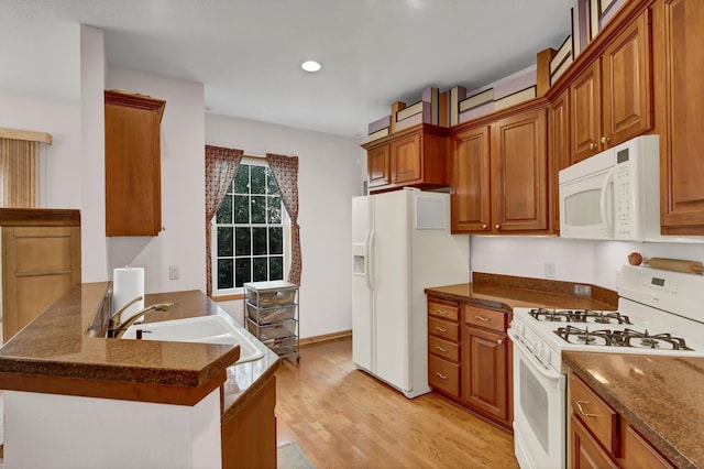 755 Hickory Way Unit 2, Lake City, MN 55041 - kitchen featuring white appliances, brown cabinetry, a peninsula, light wood-type flooring, and recessed lighting