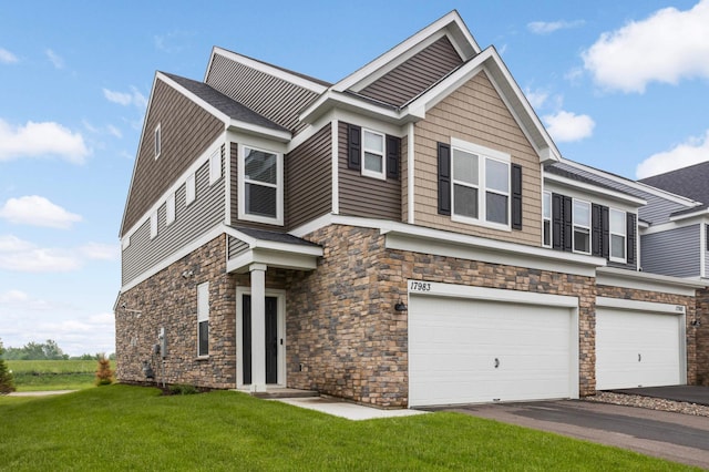 17983 Giants Way, Lakeville, MN 55044 - view of front of property with stone siding, a garage, a front lawn, and driveway