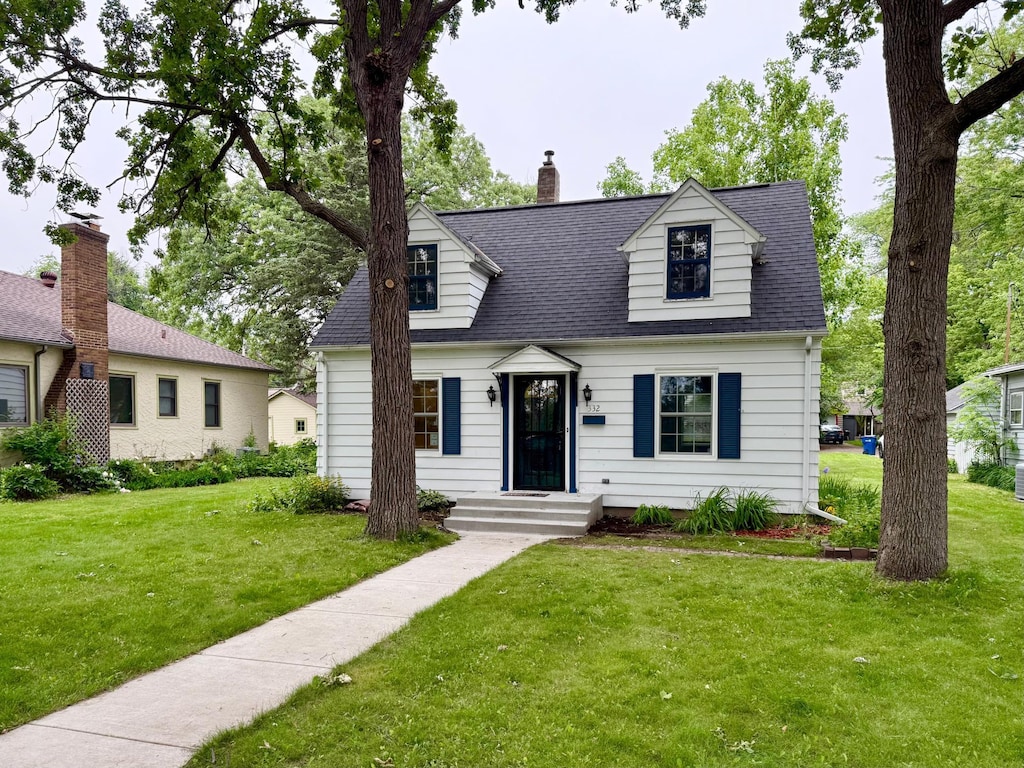 332 Riverside Dr NE, Saint Cloud, MN 56304 - cape cod home with a front lawn, a chimney, and a shingled roof