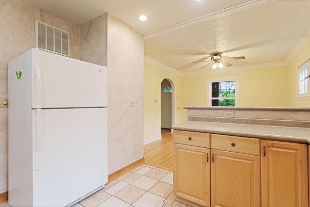 332 Riverside Dr NE, Saint Cloud, MN 56304 - kitchen with freestanding refrigerator, arched walkways, a ceiling fan, crown molding, and light brown cabinets