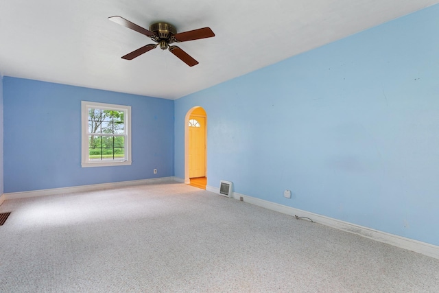 332 Riverside Dr NE, Saint Cloud, MN 56304 - empty room with carpet flooring, ceiling fan, and arched walkways