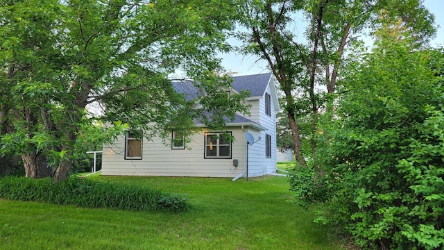 112 240th St N, Eglon Twp, MN 56549 - view of side of property with a yard and a shingled roof
