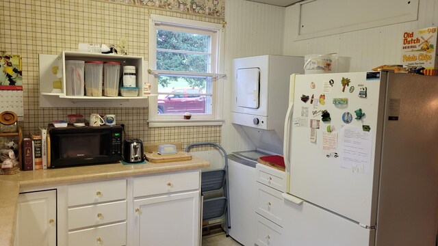 112 240th St N, Eglon Twp, MN 56549 - kitchen featuring freestanding refrigerator, black microwave, white cabinets, and light countertops